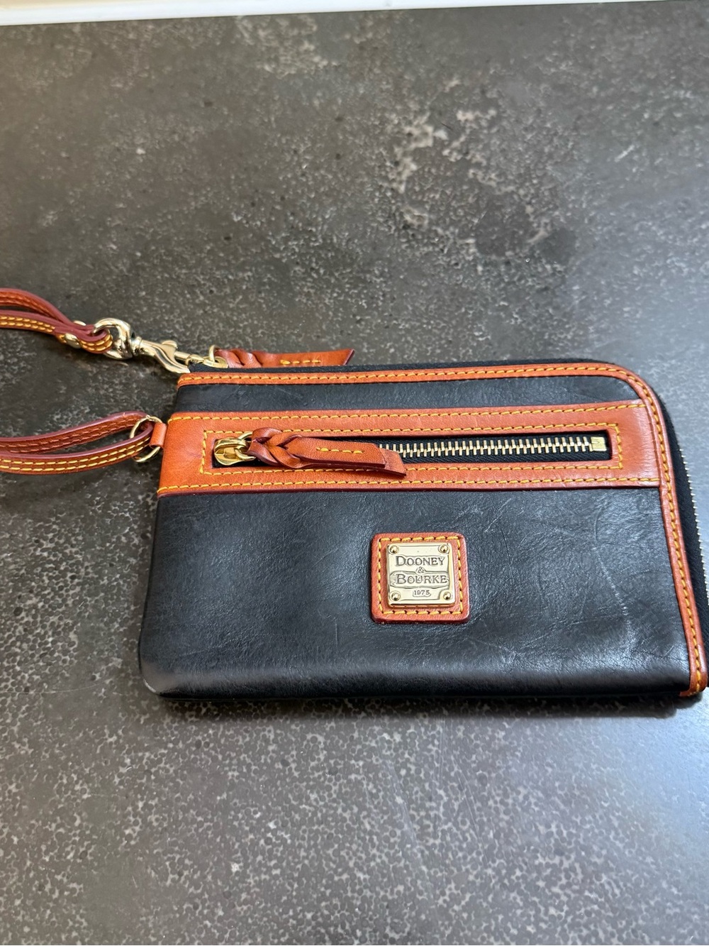 Dooney & Bourke Black Leather Wristlet with Brown Trim and Gold Plaque, 7" x 4.5